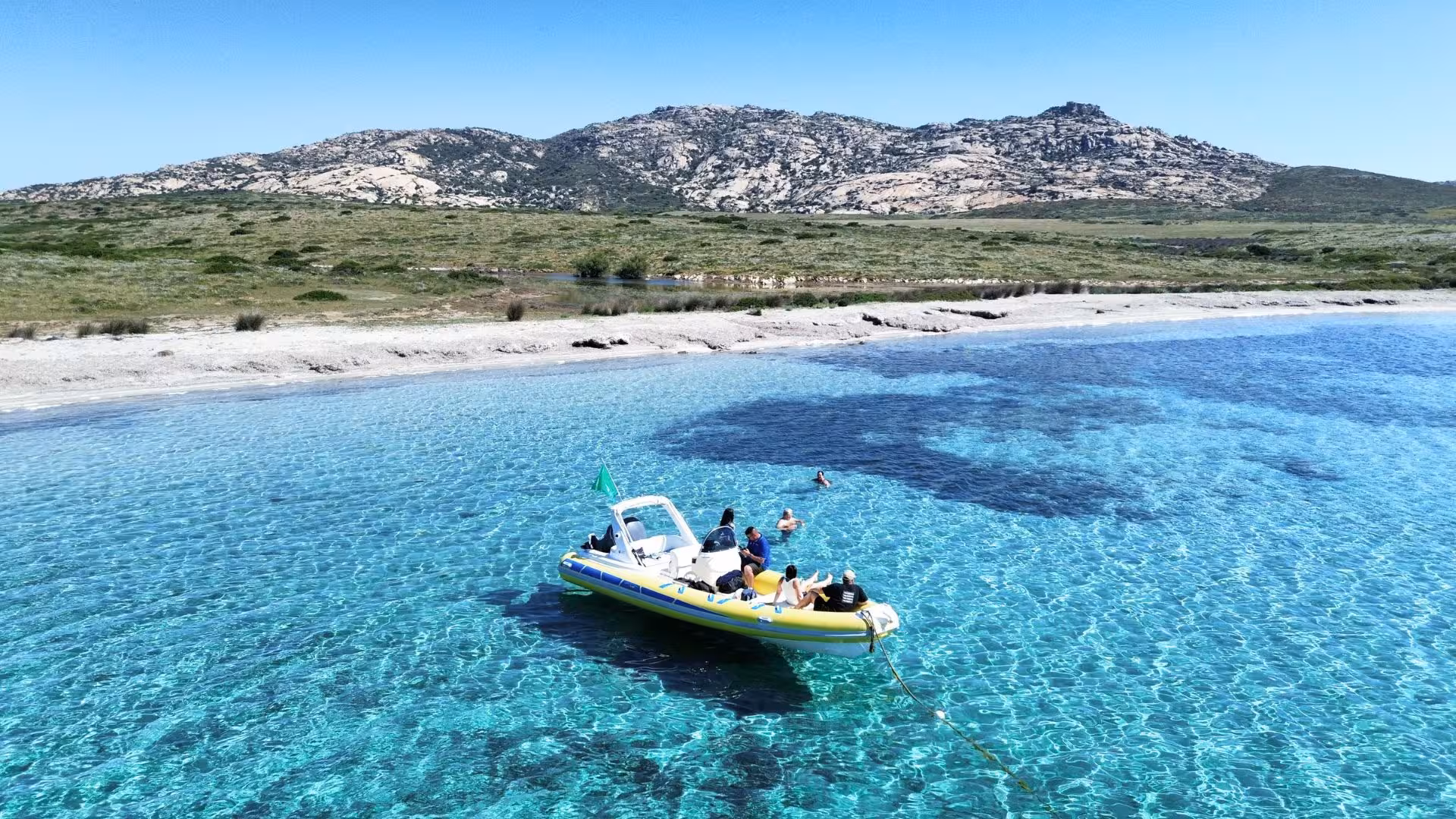 Dinghy tour in crystal-clear waters near Asinara Island, showcasing Stintino's stunning coastline and serene beaches.