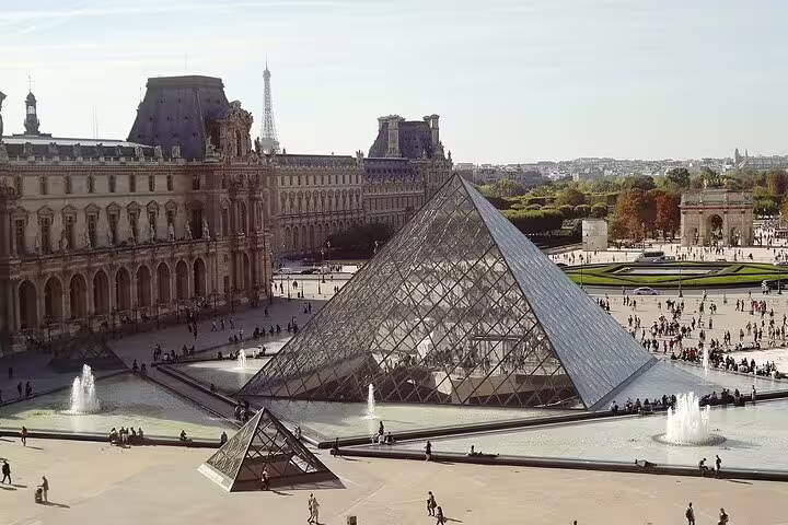 Louvre Pyramid in central Paris, convenient pickup area for Disneyland Paris private round-trip transfer