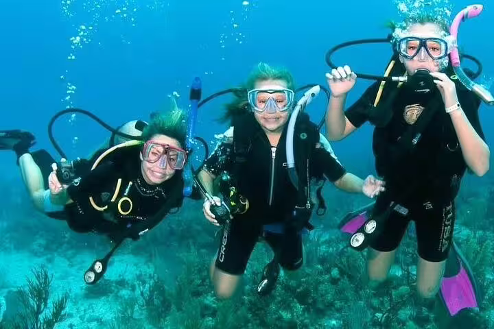Group of divers posing underwater during Red Sea VIP boat diving and snorkeling day trip from Hurghada