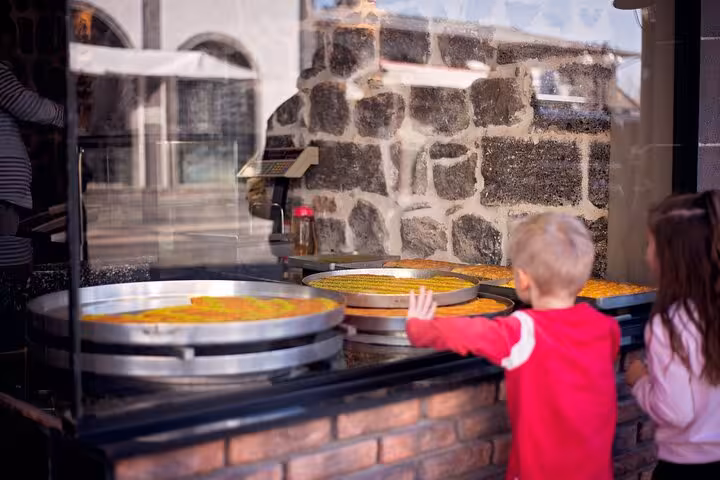 Traditional Diyarbakir kadayif dessert trays in a bazaar window, a highlight on private guided city tour