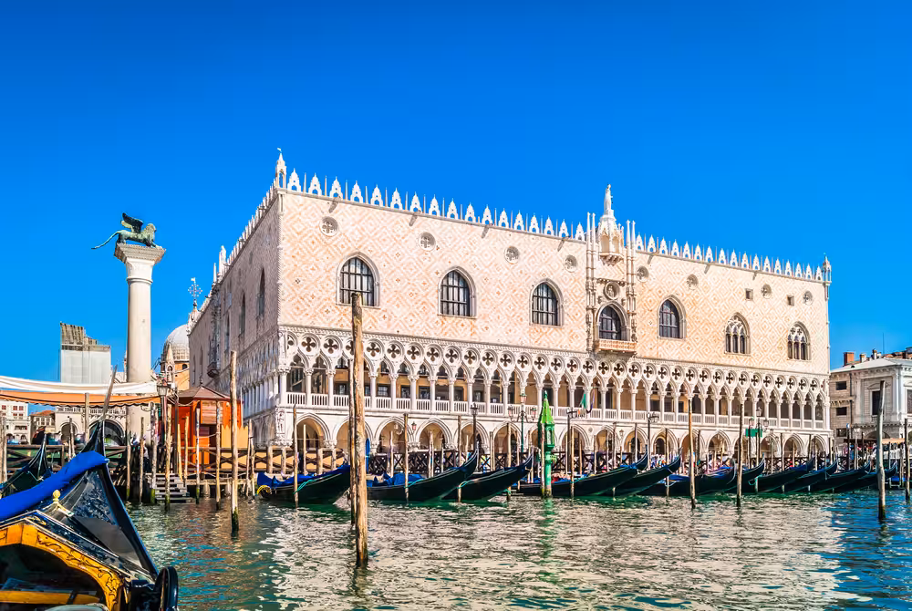 Doge's Palace with gondolas in the Grand Canal, a highlight of the Best of Venice walking tour experience.