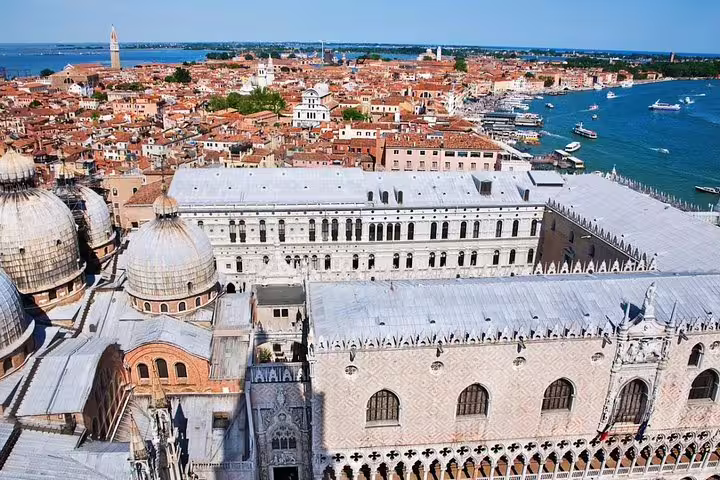 Aerial view of Doge’s Palace and St. Mark’s Basilica domes on a small group tour overlooking Venice lagoon and Grand Canal