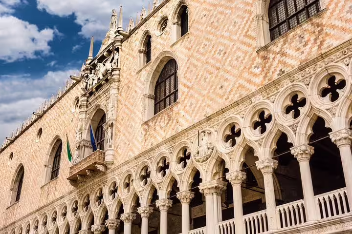 Ornate Gothic façade and arches of Doge’s Palace in Venice seen on a small group tour with knowledgeable local guide