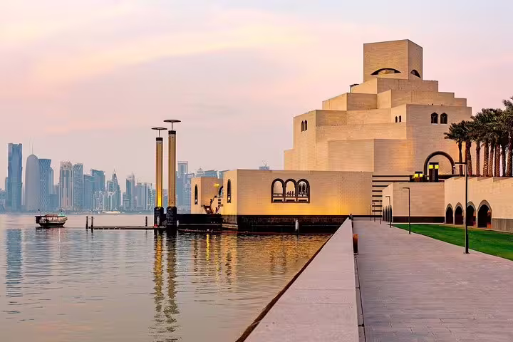 Scenic view of Doha's Museum of Islamic Art at sunset, highlighting Qatar's rich culture on a city adventure tour.