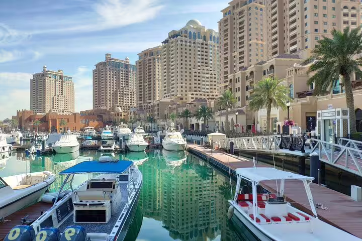 Luxurious marina at The Pearl-Qatar showcasing yachts and modern architecture on the Doha City Tour.