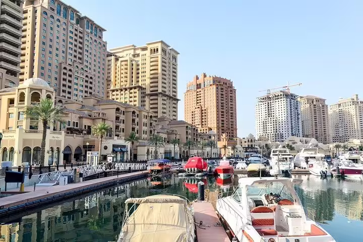 Experience luxury at The Pearl-Qatar marina with its modern skyline and yachts on your Doha private city tour.