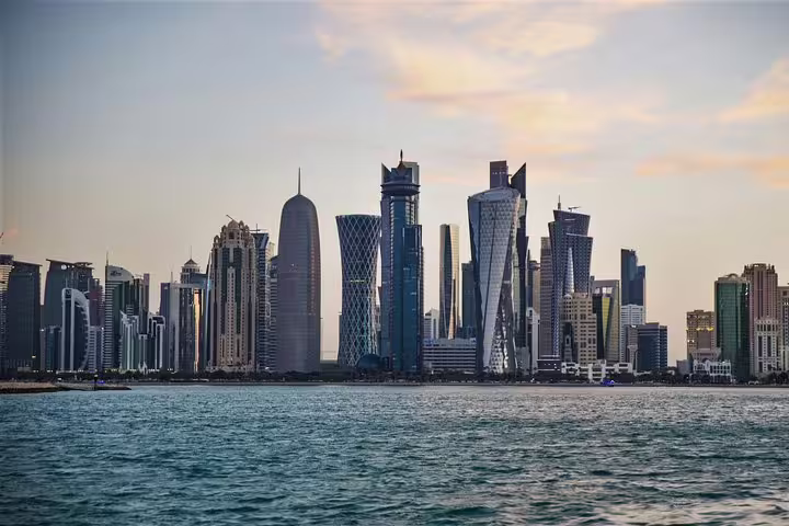 Stunning Doha skyline with modern skyscrapers against a serene waterfront, highlighting Qatar's urban beauty.