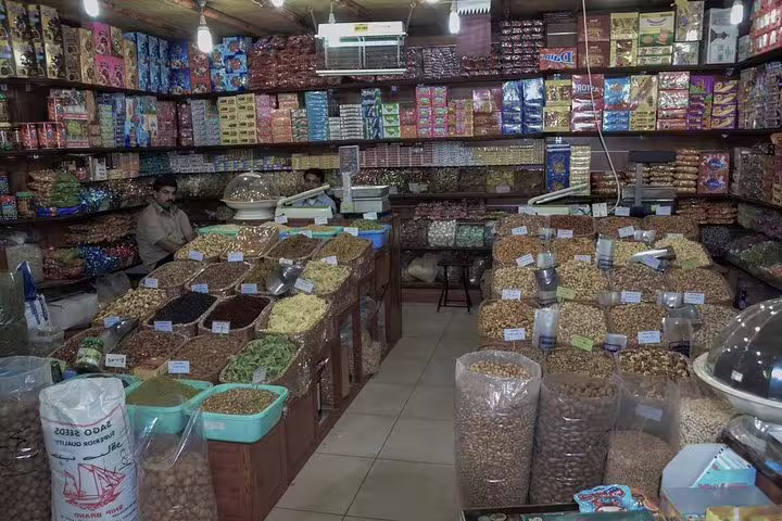 Vibrant Doha spice market showcasing a variety of colorful spices and nuts, perfect for cultural exploration.