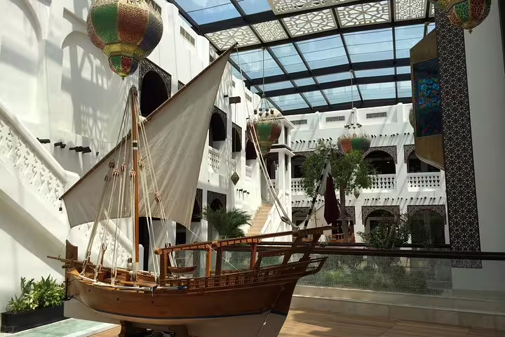 Traditional dhow in the atrium of Katara Cultural Village, a highlight of the Doha Transit City Tour from Hamad Airport.