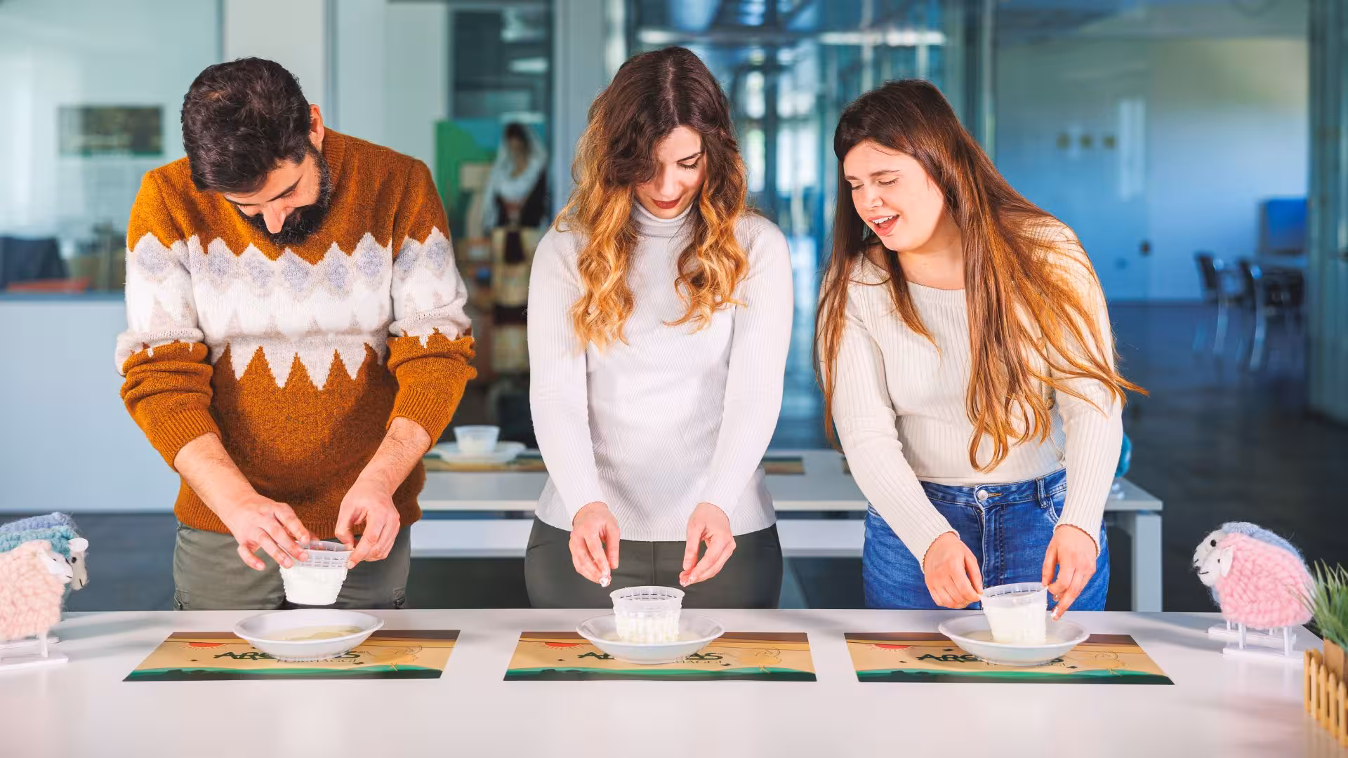 Participants molding fresh cheese during hands-on workshop at Dolianova cheese factory visit.
