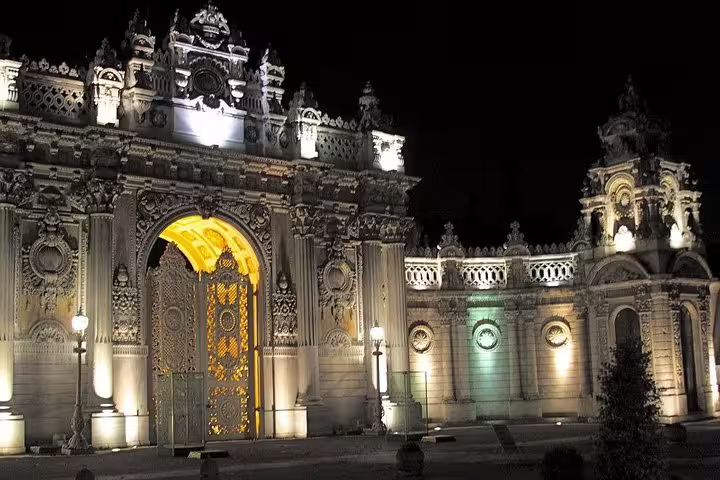 Dolmabahce Palace gate lit up at night, elegant stop on a private Istanbul by night sightseeing experience