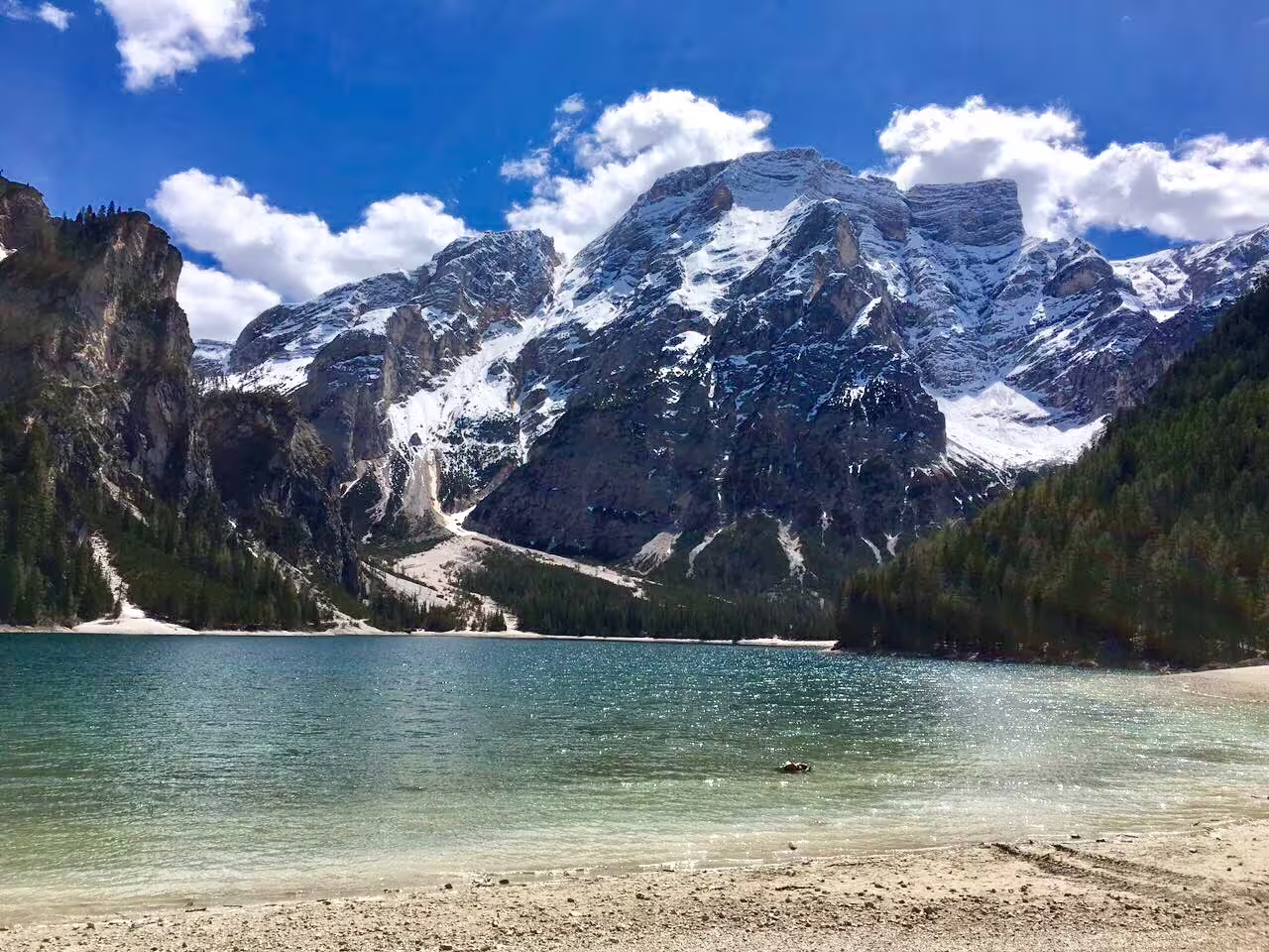 Crystal-clear lake nestled below snow-capped Dolomites peaks on private day trip from Venice by Mercedes Viano.