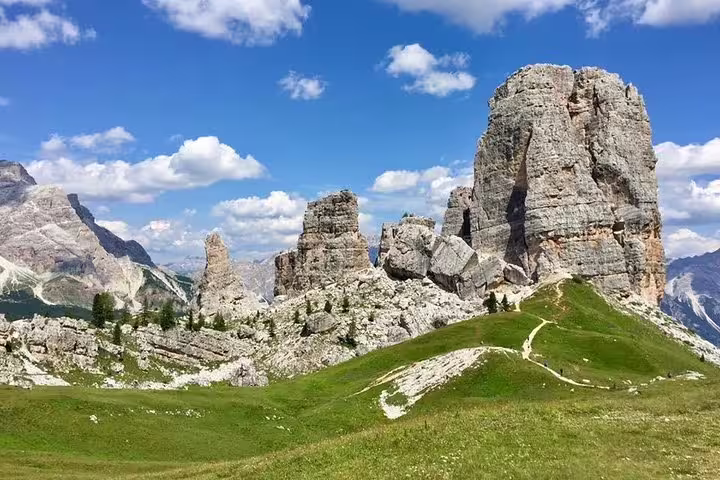 Stunning rock formations in the Dolomites under a bright blue sky, ideal for a private day tour from Venice.