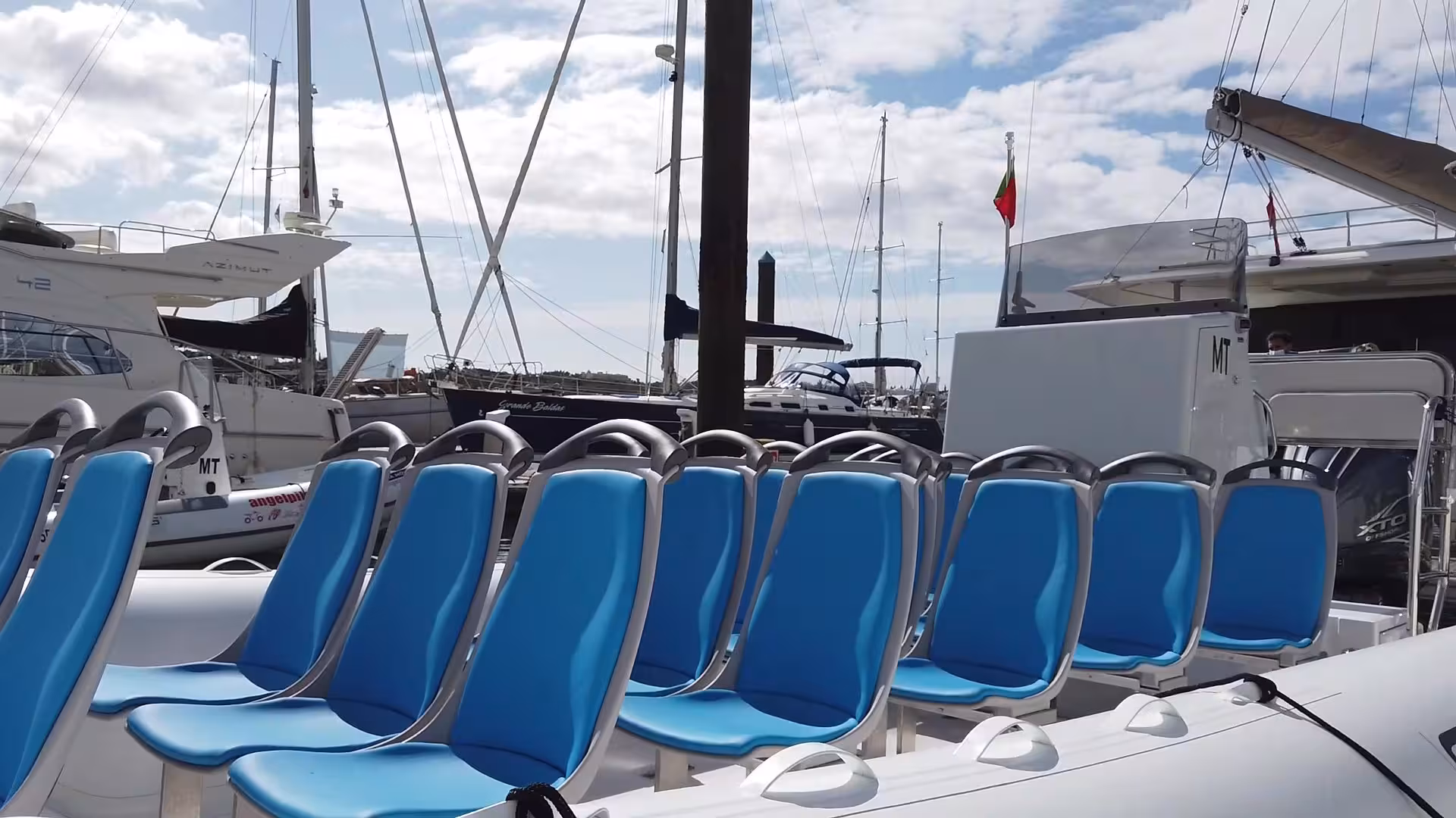 Comfortable seating on a tour boat docked at a marina, ideal for dolphin watching and exploring sea caves.