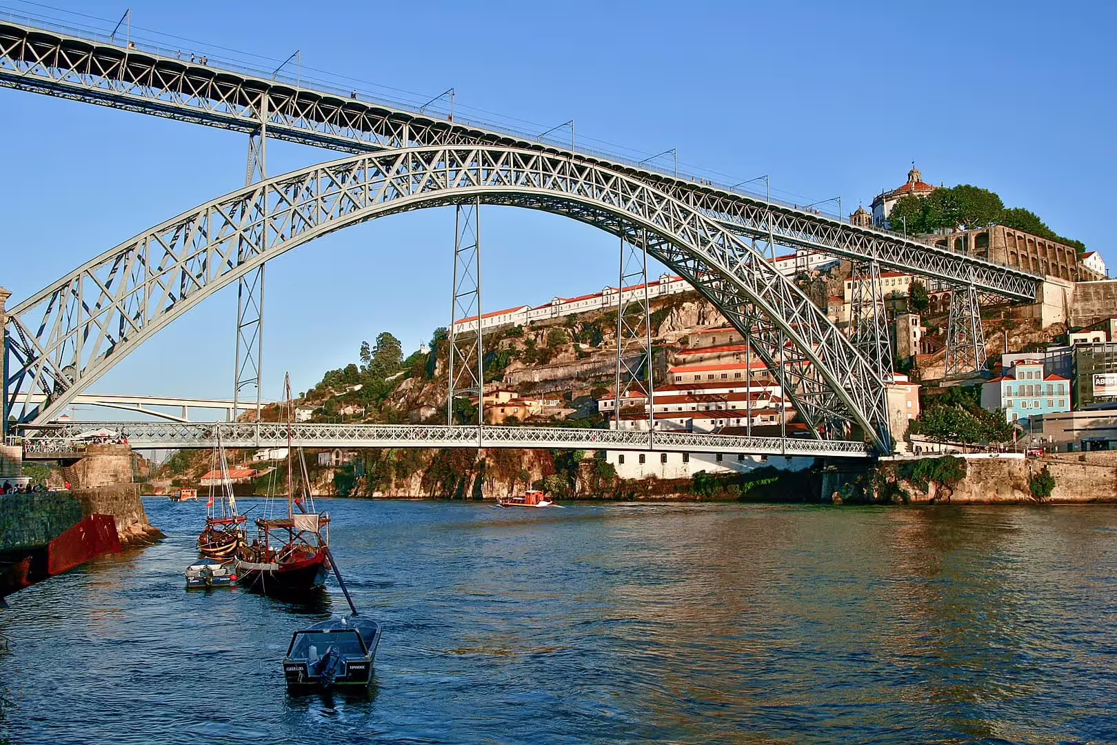 Iconic Dom Luís I Bridge spanning the Douro River in Porto, captured during a scenic small-group walking and river cruise tour.