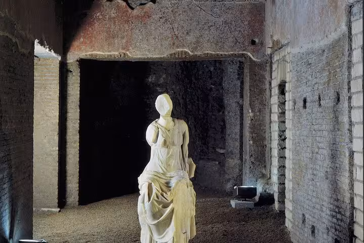 Ancient statue in the dimly lit interior of Domus Aurea, showcasing Roman history and architecture in Rome VR tour.