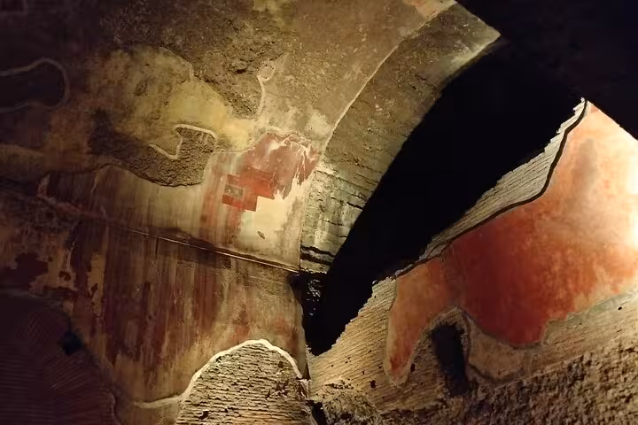 Colorful frescoes and ancient arches inside Rome's Domus Aurea, highlighting its historical artistry.