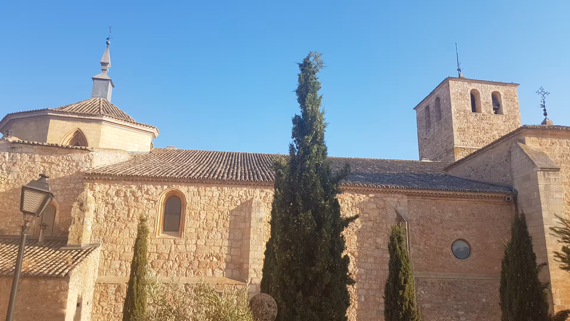Historic stone church with bell tower in La Mancha, a highlight stop on the Don Quixote Tour in Spain
