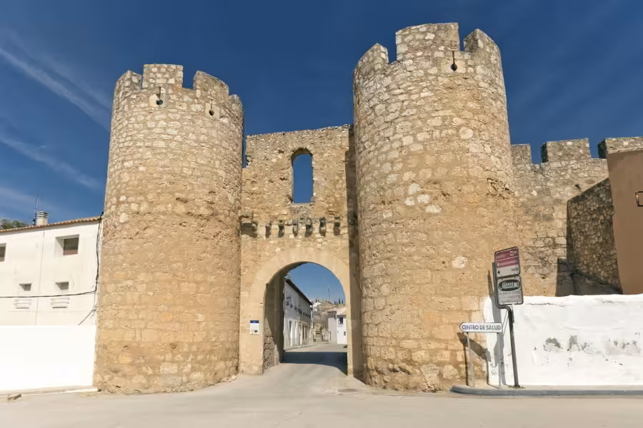 Ancient fortified gate and towers in a La Mancha village, cultural landmark on the Don Quixote Tour route