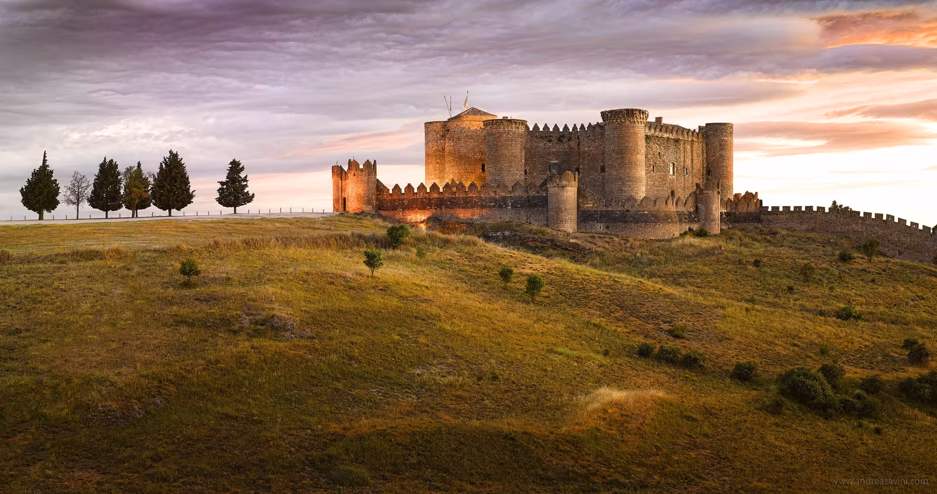 Sunset view of a medieval La Mancha castle, a highlight stop on the Don Quixote Tour in Spain