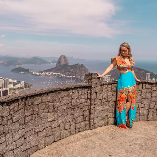 Woman enjoying panoramic views from Dona Marta Viewpoint, overlooking Rio de Janeiro and Sugarloaf Mountain.
