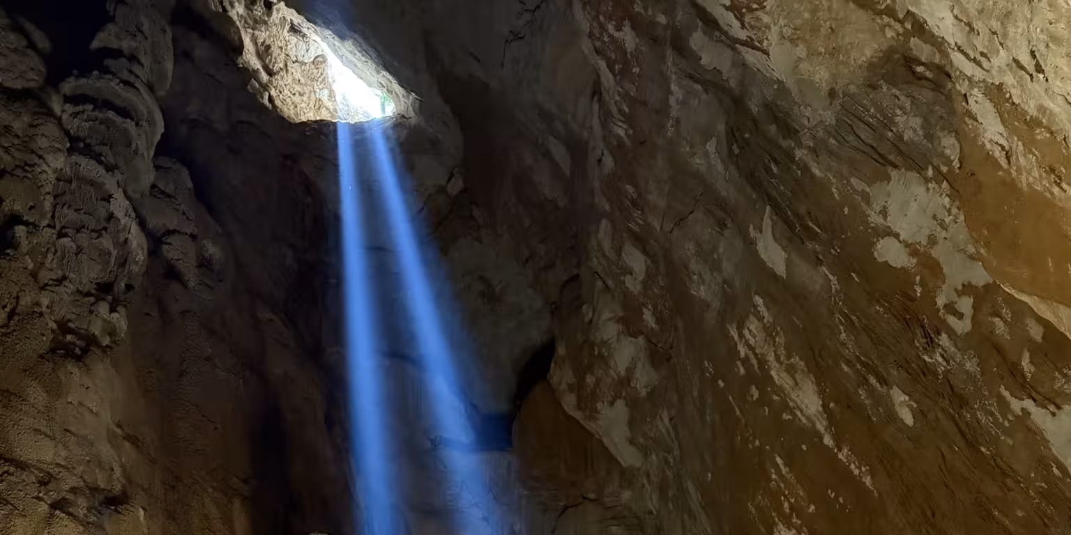Sunlight streams into Sa Nurre de Su Hoda Cave, illuminating its intricate rock formations during a Dorgali trek.