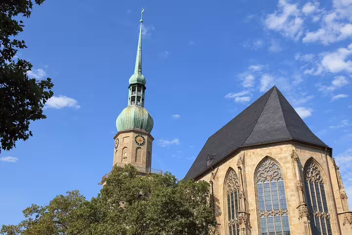 Dortmund church spire and Gothic windows under blue sky, highlight on a self-guided scavenger hunt tour