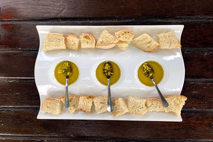 Portuguese olive oil tasting with bread on a white platter, gourmet stop on a private Douro luxury tour