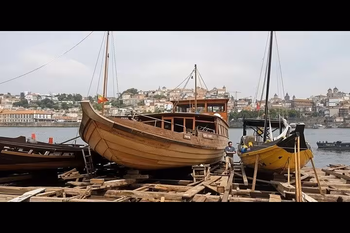Traditional Douro rabelo boats in Porto riverside, part of private sunset tour with wine tastings and Fado dinner