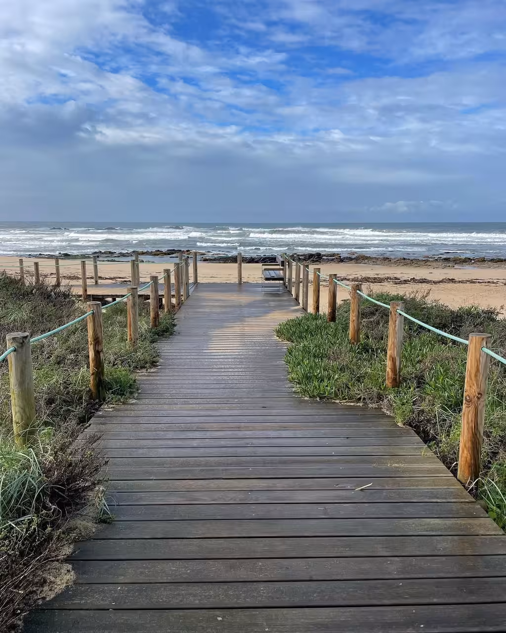 Wooden boardwalk leading to a wild Atlantic beach near the Douro River, scenic beaches stop on vintage car tour