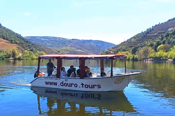 Boat cruise on the Douro River in Pinhão, Portugal, with terraced vineyards and scenic valley views