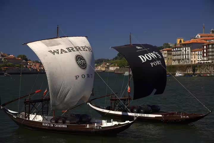 Historic port wine boats on Douro River, showcasing Portugal's rich wine heritage on a small group tour from Lisbon.