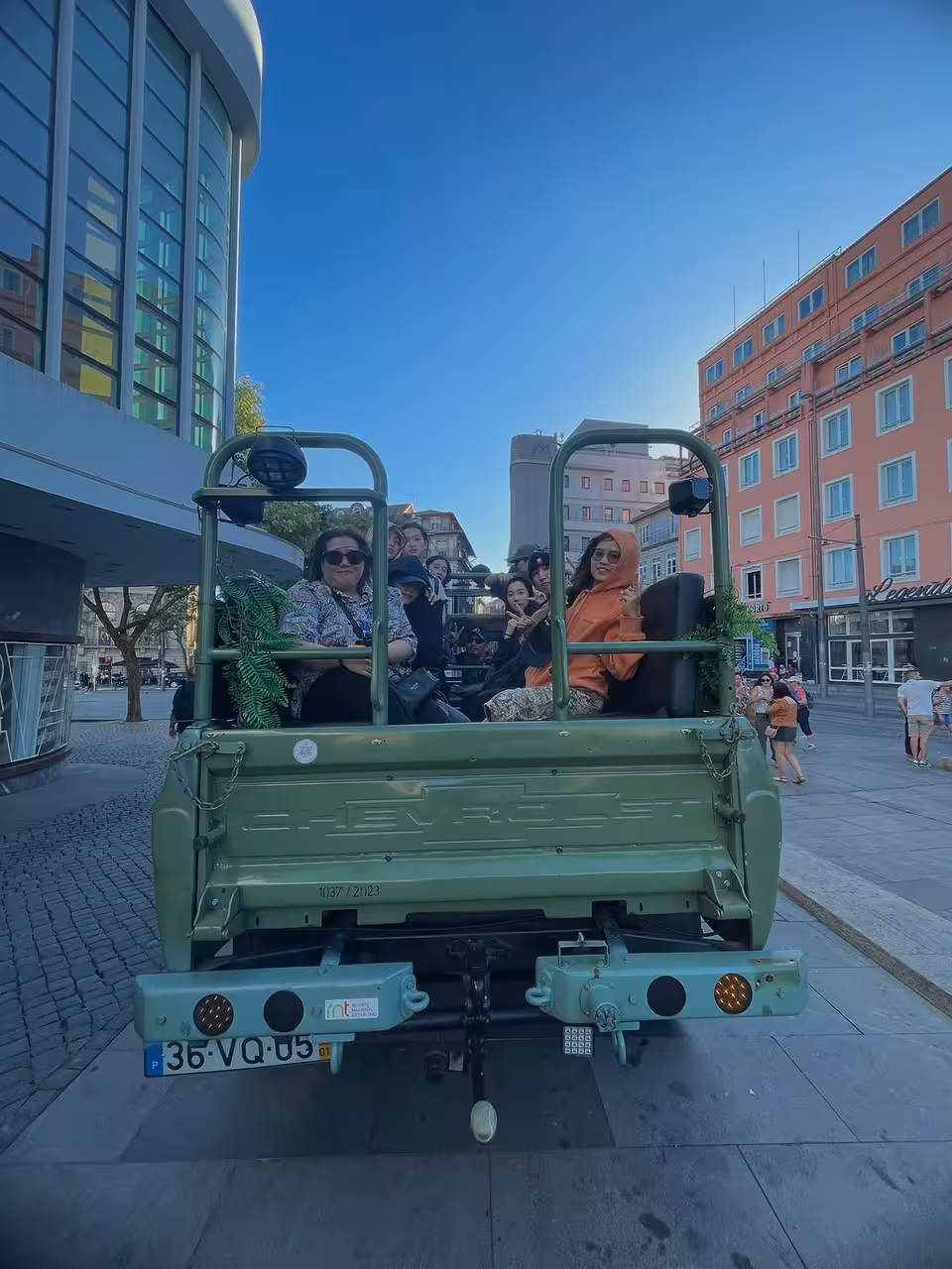Travelers on open-top vintage jeep in Porto, starting Douro River scenic beaches, historic mills and hidden gems tour