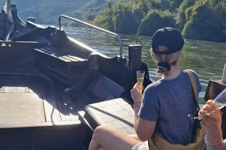 Guests sipping sparkling wine on a Douro Valley boat cruise, part of expert guide lunch and tastings offer