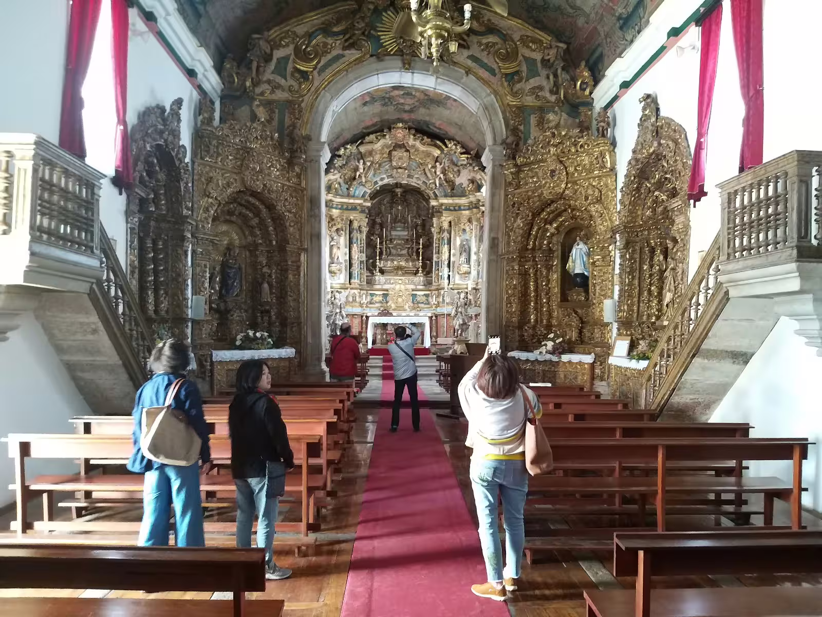 Visitors admire the ornate interior of a historic church in the Douro Valley, a highlight of the renowned winery tour.