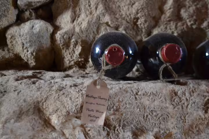 Vintage port wine bottles with wax seals and tags, highlighting the authentic wine experience in Douro Valley.