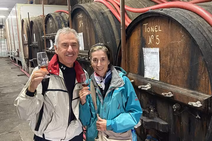 Guests tasting Port wine in a Douro Valley winery cellar on a private guided tour with tastings and lunch