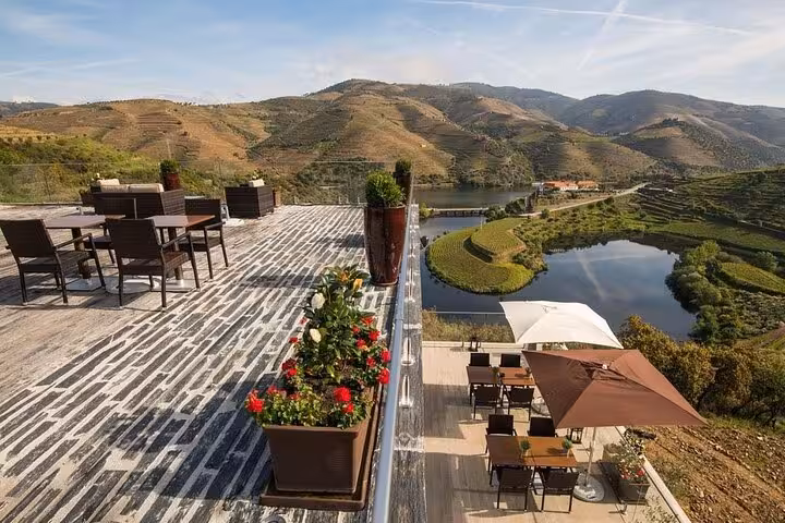 Riverside terrace overlooking Douro Valley vineyards, ideal stop on private guide tour with wineries and lunch