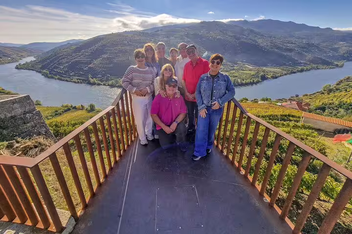 Group at Douro Valley viewpoint overlooking river and vineyards, ideal stop on a 2-day private Lisbon to Porto tour