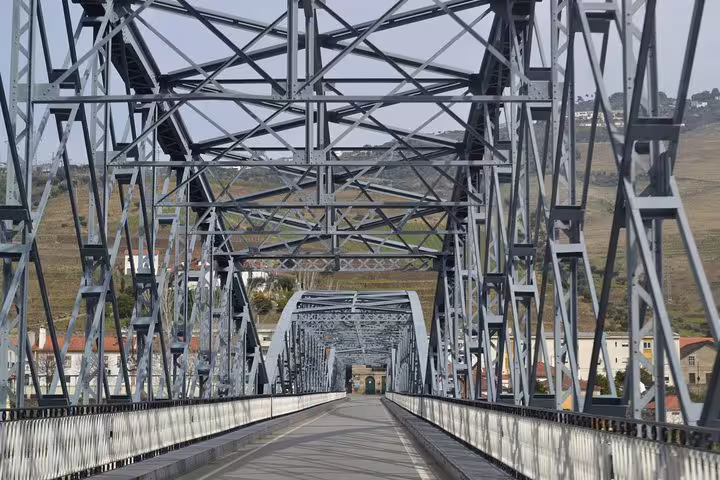 Architectural bridge crossing in Douro Valley surrounded by scenic vineyards and rural landscape.