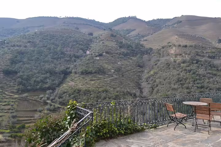 Inviting terrace with seating overlooking the breathtaking, terraced hills of Douro Valley in Portugal.