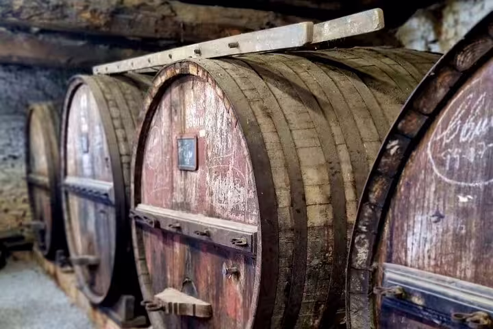 Rustic wine barrels in a traditional Douro Valley cellar, highlighting the authentic vineyard experience.
