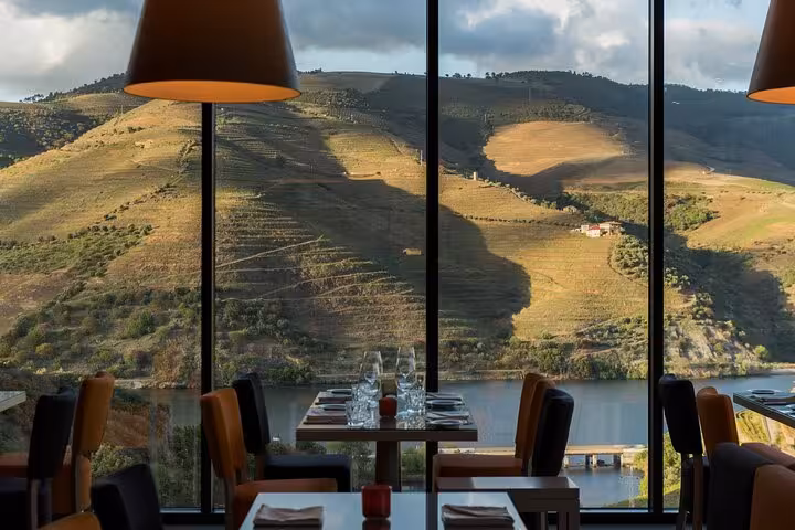 Wine estate dining room with panoramic Douro River and vineyard views, part of private Douro Valley tasting tour