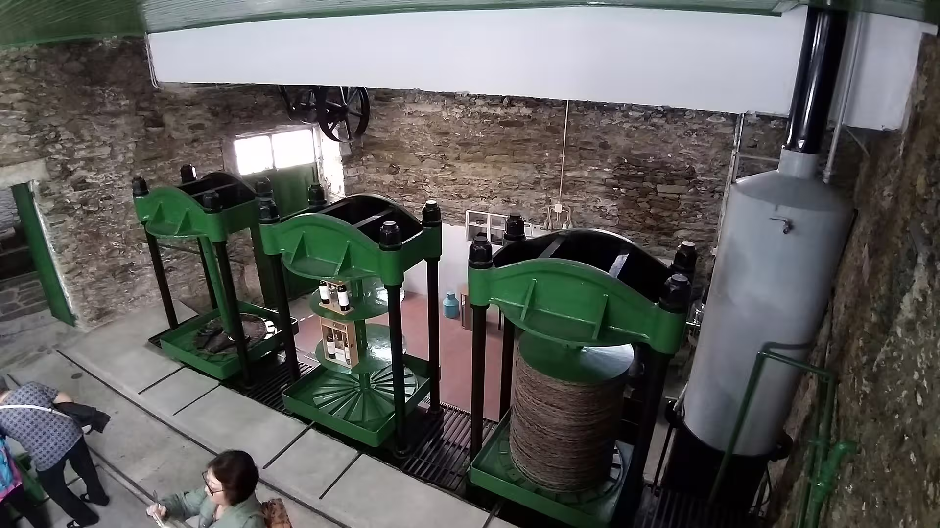 Traditional wine press machinery in a rustic Douro Valley winery, highlighting the authentic winemaking process on the Foz Côa tour.