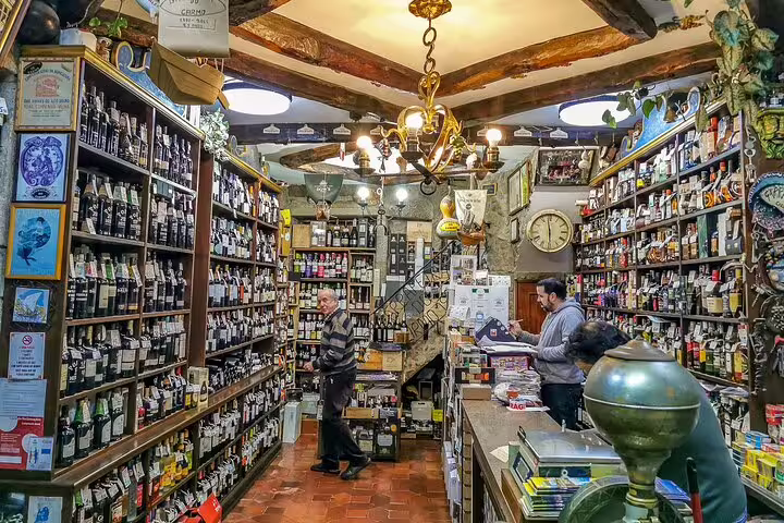 Cozy wine shop in Douro Valley with rustic decor, offering a wide selection of local wines on a private tour from Lisbon.