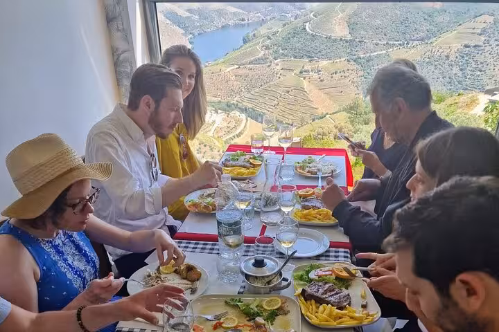 Douro Valley lunch with wine tasting on terrace, expert-guided tour overlooking river and vineyards