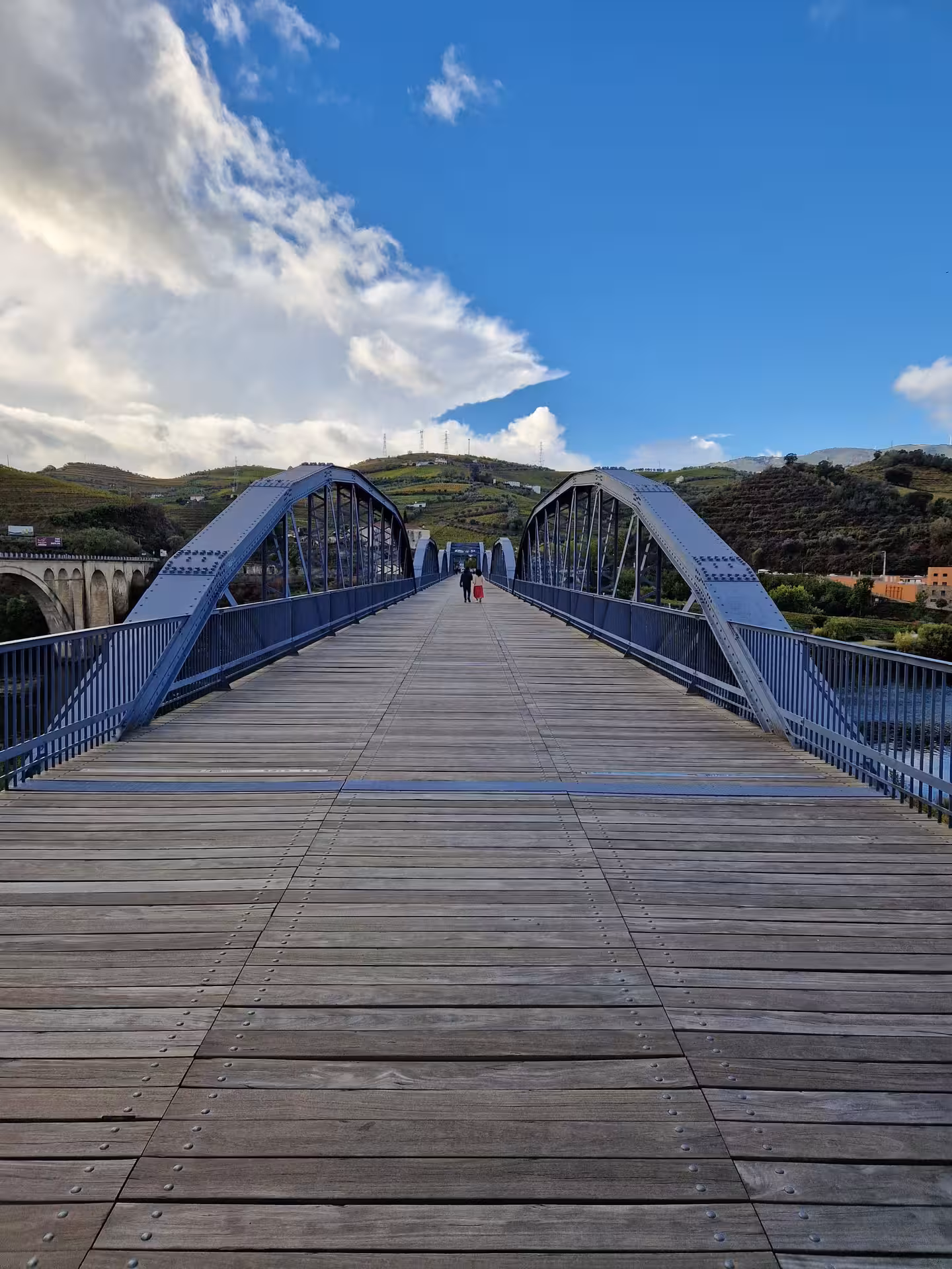 Walking across steel bridge in the Douro Valley, Portugal, on a full-day wine tasting, boat trip and lunch tour