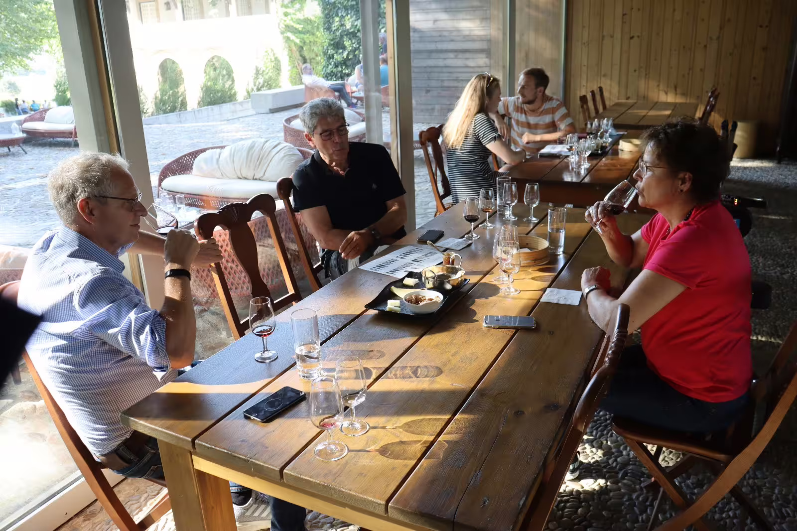 Guests enjoy wine tasting at a rustic winery in Douro Valley, experiencing the region's finest selections and scenic charm.