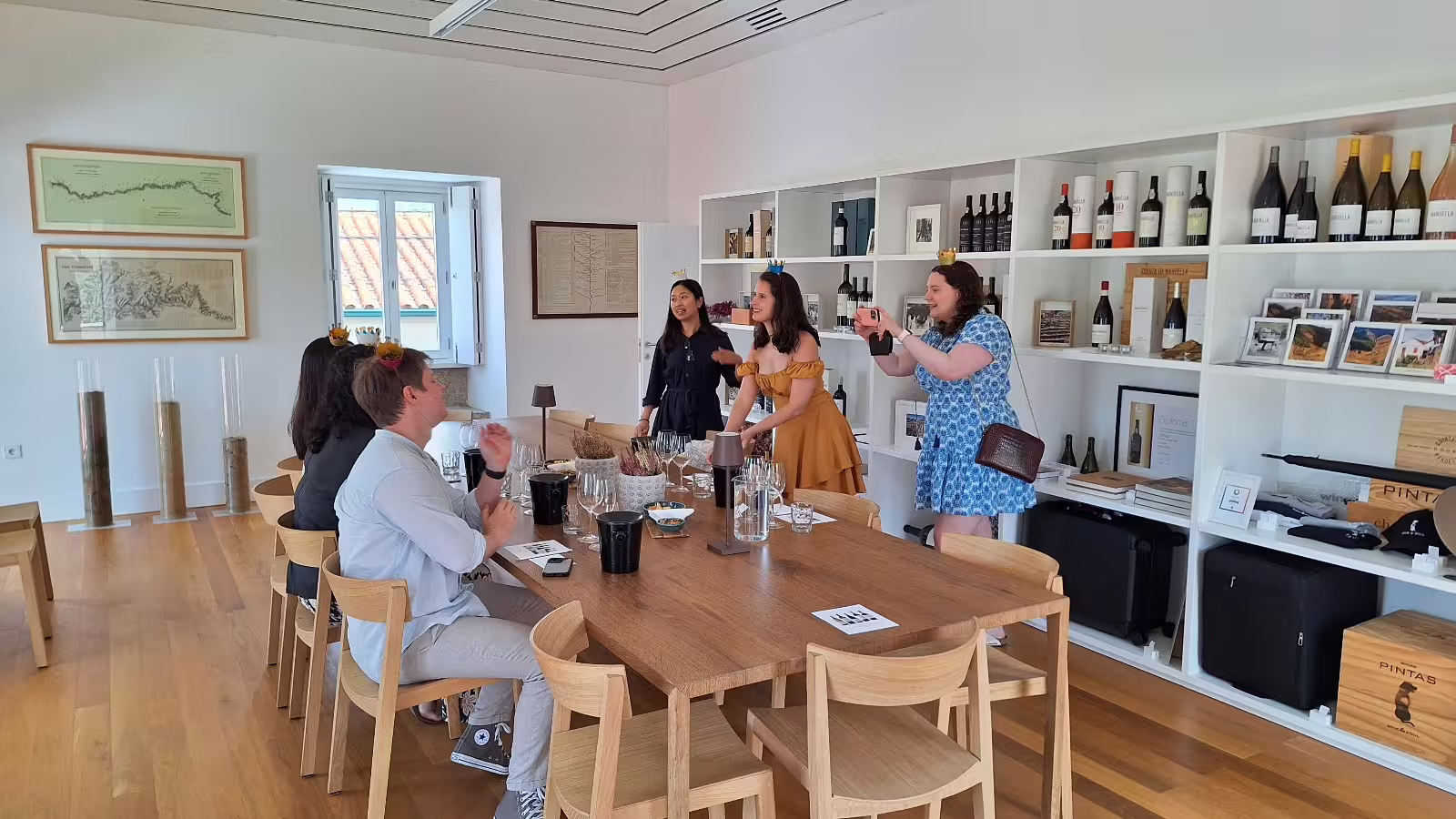 Guests enjoying a wine tasting session at a renowned Douro Valley winery with scenic river views in the background.