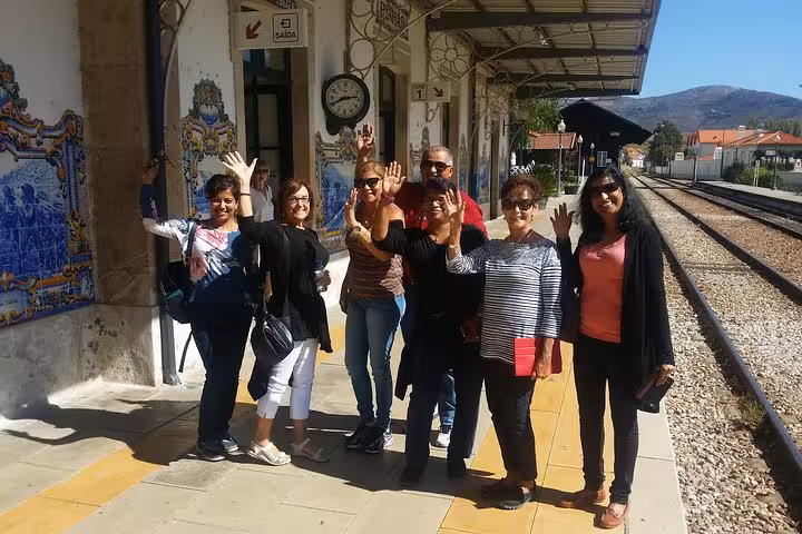 Group at Douro Valley train station on guided wine tour, heading to boat cruise, lunch and tastings experience